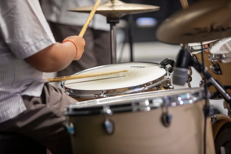 a drum set being played by a student