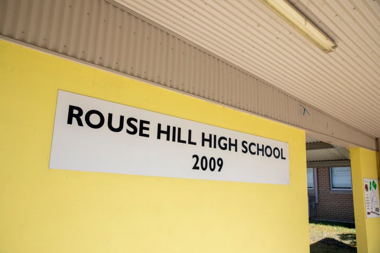 A yellow entrance wall with a 'Rouse Hill High School 2009' sign